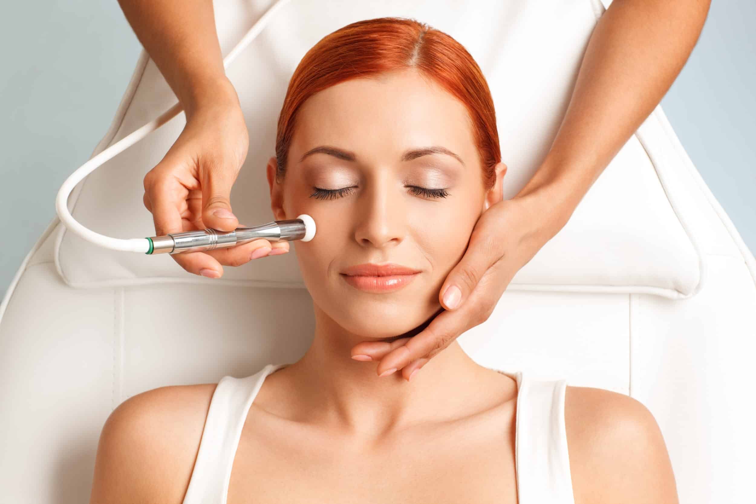 Close up of a happy woman receiving a microdermabrasion facial treatment
